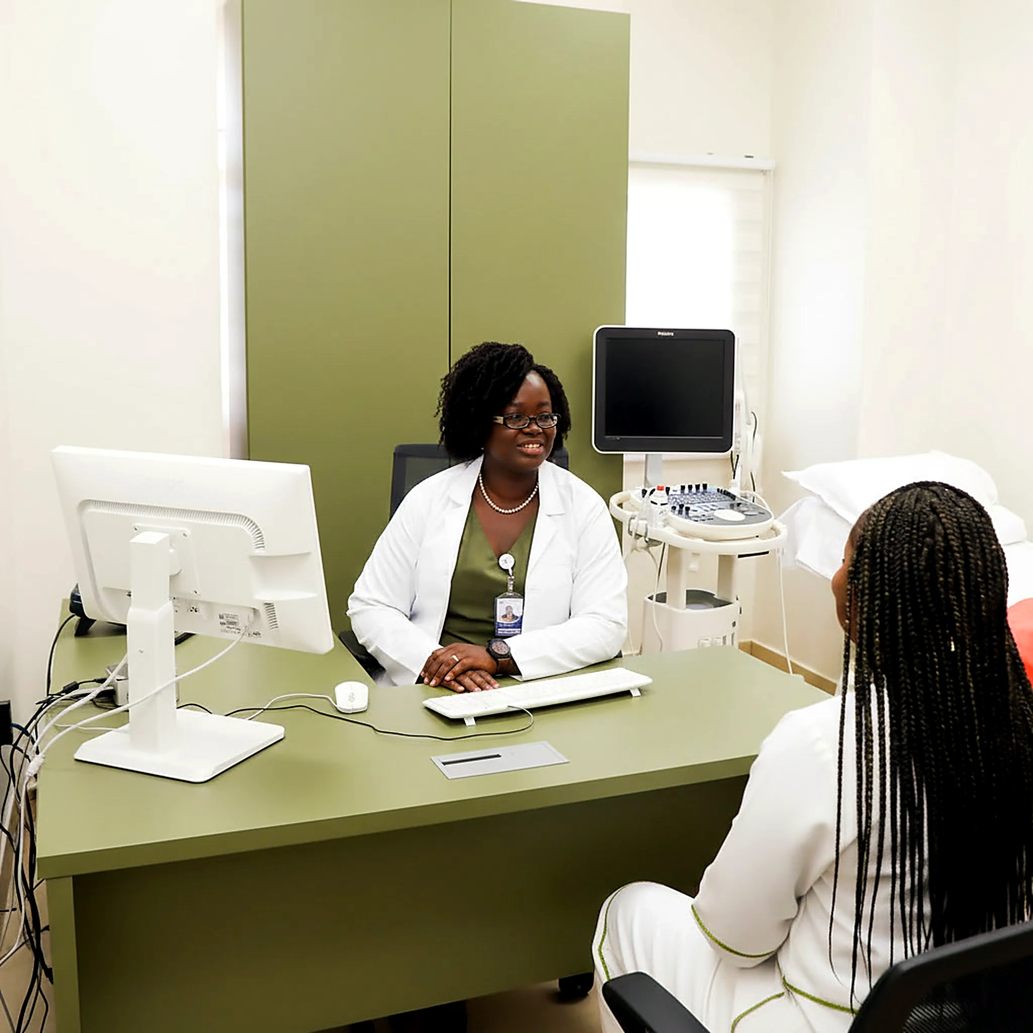 A minister speaking with a health professional in a consultation room; an AI-generated illustrative scene.